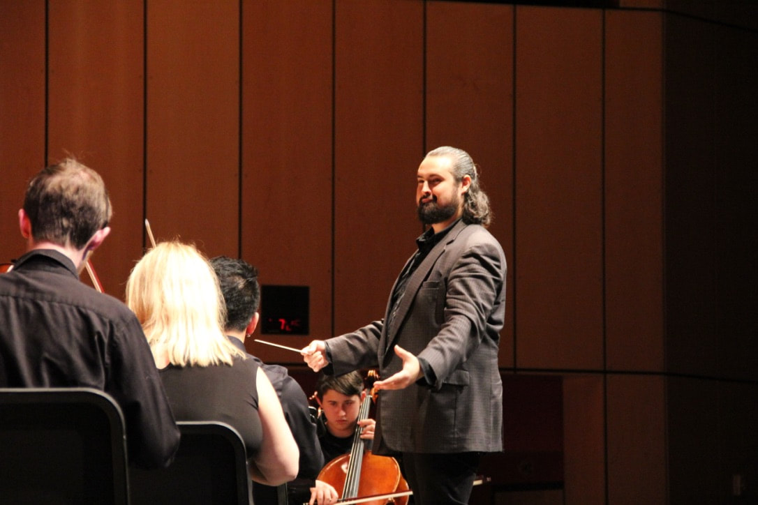 Mike Jauregui conducting an orchestra
